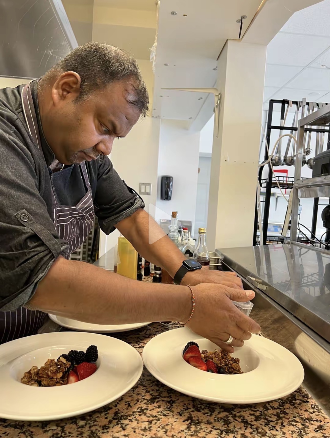 Chef Saku plating granola and berries